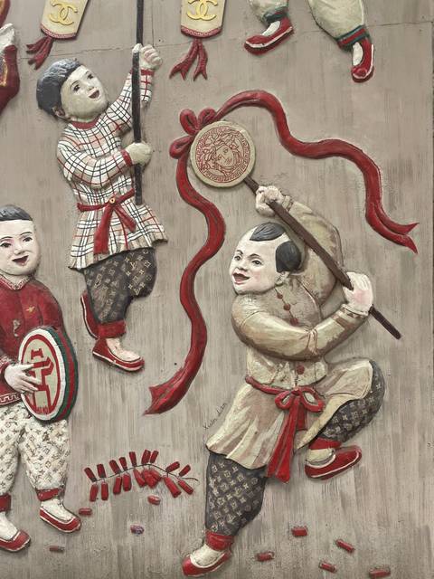 Traditional carved mural showing figures in action poses.