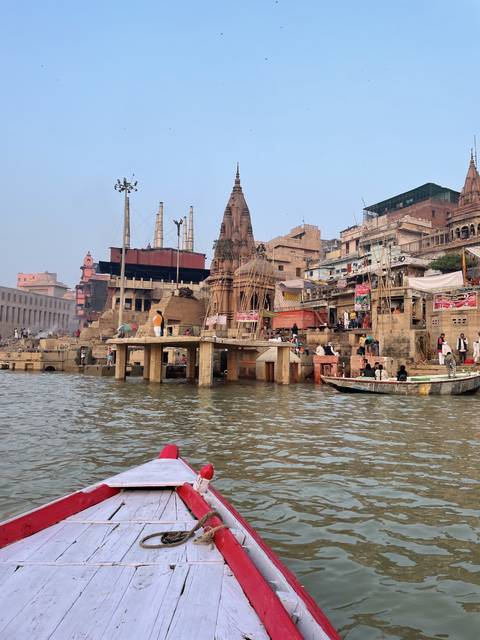       Boats on a river with a view of the city in the background.
  
