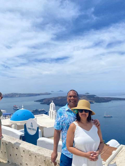 Couple posing with a view of the ocean and islands.