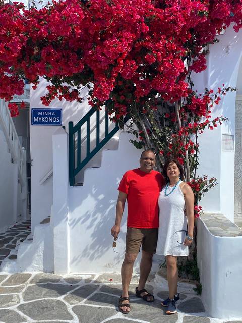Couple posing with trees and a staircase.