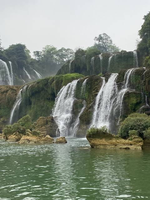       Waterfall cascading into a clear pool.
  