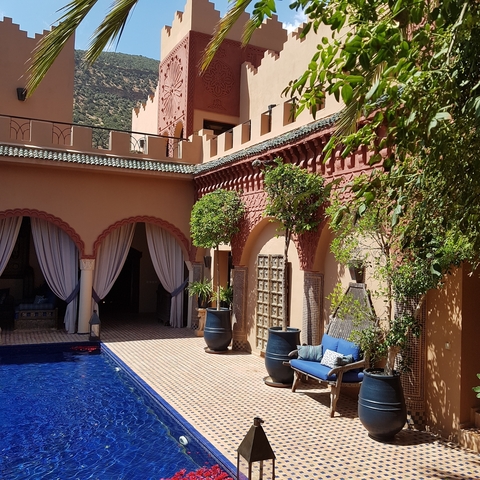       Luxurious courtyard with pool and traditional architecture.
  