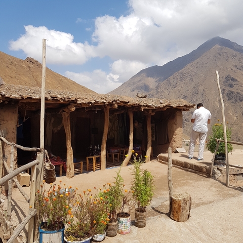 A person standing outside a rustic mountain building.