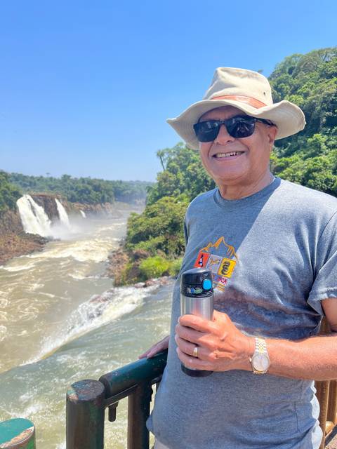 Person with sunglasses and hat at Iguazu Falls