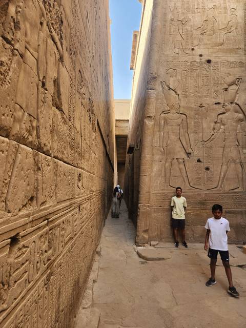 Visitors walking through an ancient temple site.