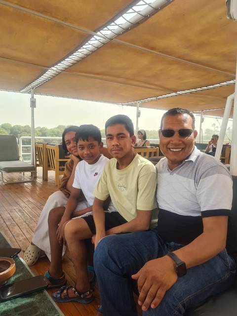 Group of people sitting on a boat.