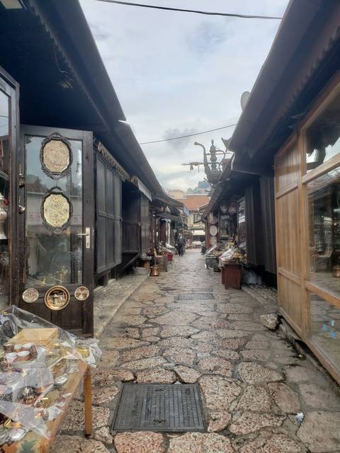 Narrow street in a rustic market with shops.
