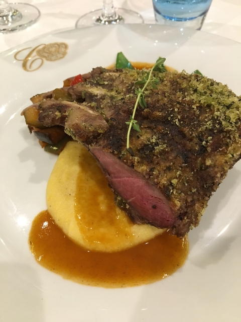Herb-crusted roast beef on a plate.