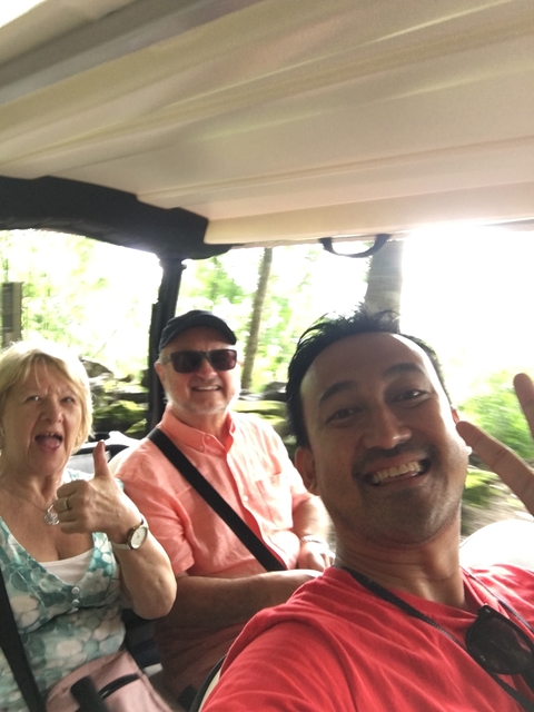 Selfie of a group of people in a moving vehicle.