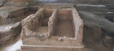 Antique stone structures carved out of rock.