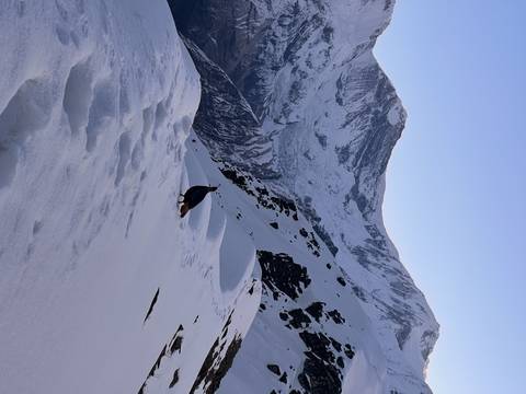       Snowy mountains with a blue sky.
  