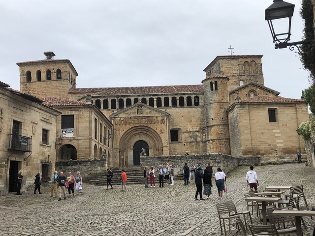       Historic cathedral with people walking in front.
  