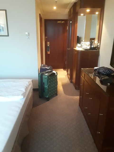 Interior of a hotel room with luggage.