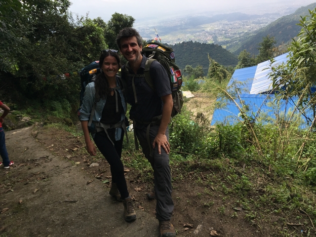       Couple of hikers posing on a trail with a scenic view.
  