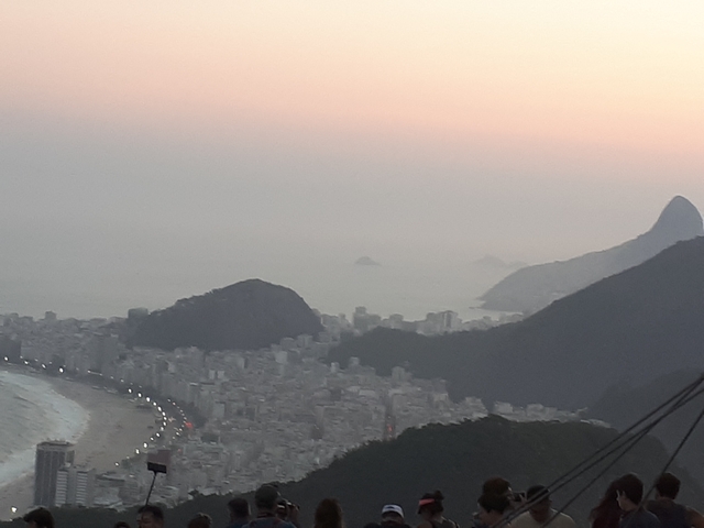 Distant view of a coastal city at sunset.