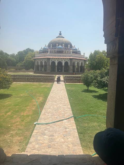       Historic structure with dome observed from garden path.
  