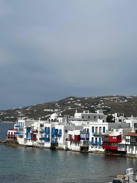 Colorful buildings along the waterfront on a cloudy day.