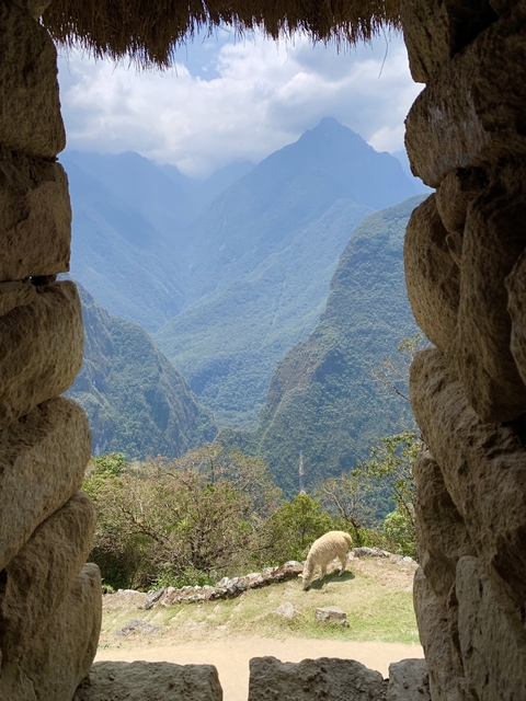       Mountainous landscape viewed through ancient stone walls.
  