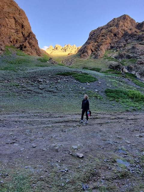 Person walking on a mountain trail.