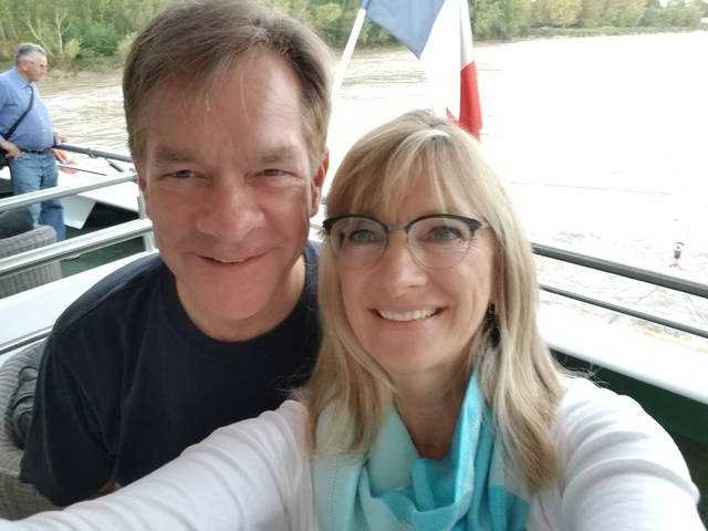       A couple taking a selfie on a boat.
  