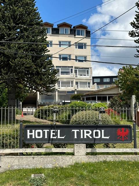       Street view featuring Hotel Tirol sign and building.
  