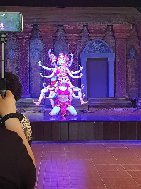 Theatrical performance with dancers in colorful costumes.