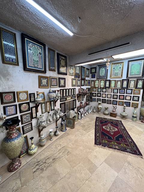       A room decorated with various frames and ceramics.
  