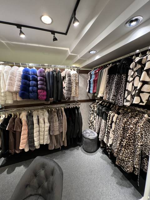       A clothing store displaying coats and jackets.
  