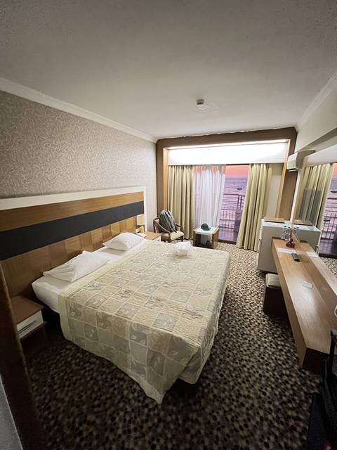       A hotel room with a large bed.
  