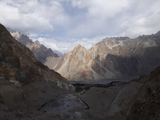       A dramatic landscape view with rocky mountains.
  