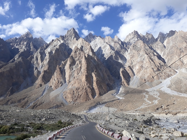       Jagged peaks with a road winding through rocky mountain terrain.
  