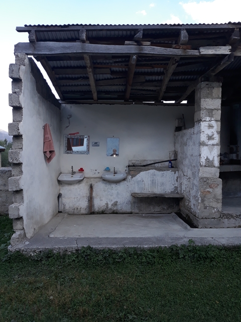 An outdoor makeshift washroom with two sinks.