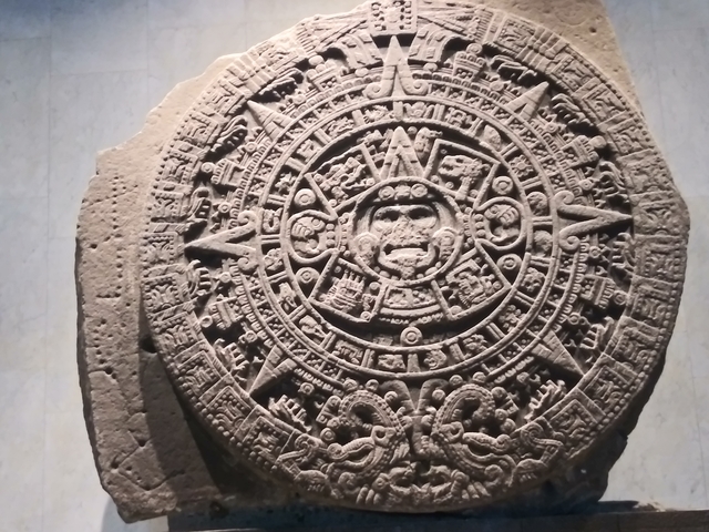       Close-up of the Aztec calendar stone with intricate carvings.
  