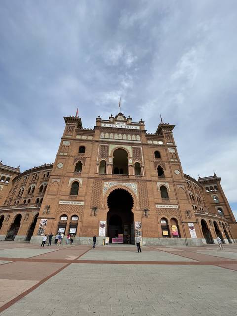 Decorative building with arches in a plaza.