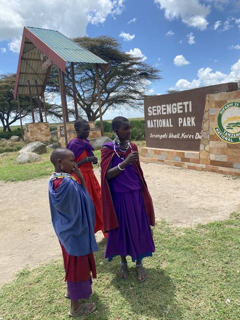       Cultural group in traditional attire at Serengeti park entrance.
  