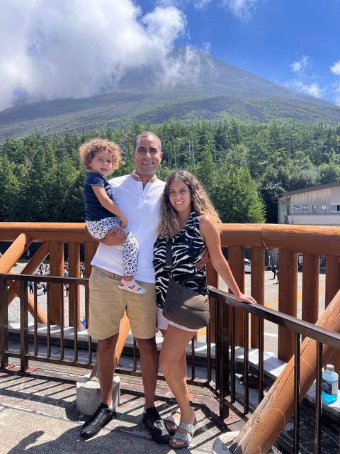 Family with a scenic mountainside view.
