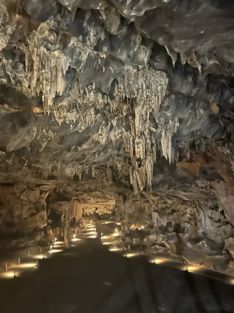 Stalactites and rock formations inside a cave.