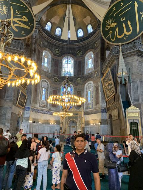       Interior of a historical building with people inside.
  