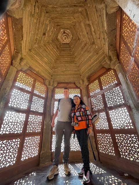       Couple standing under an intricately designed ceiling.
  