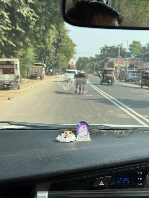       View from inside a car driving down a road.
  