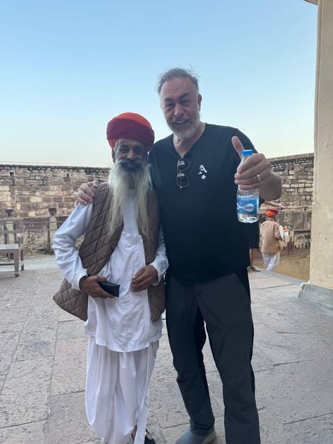       Two men posing at a historical site.
  