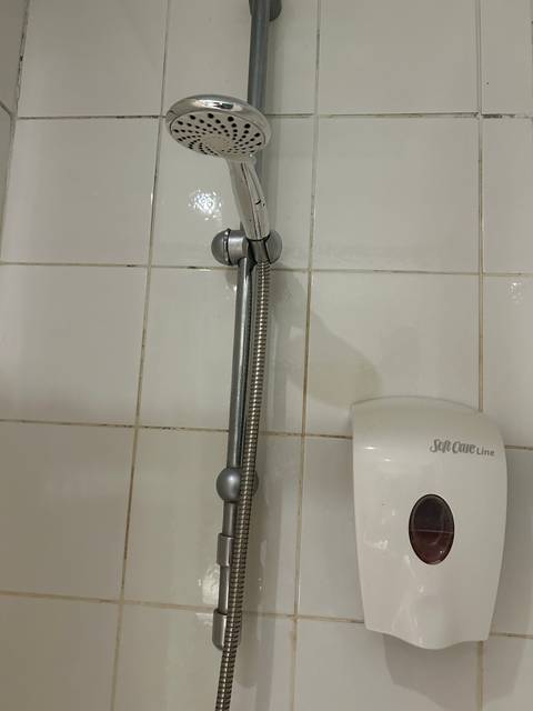 Shower head and tiled wall.