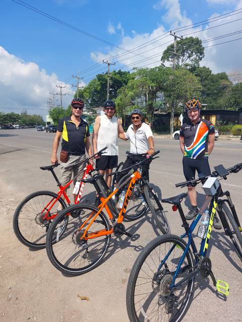 People with bicycles posing on a road