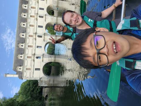 Group selfie rowing in front of a historical chateau.