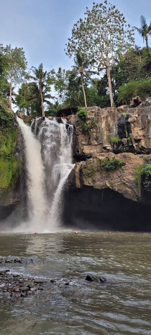 A waterfall cascading down rocks into a pool below.