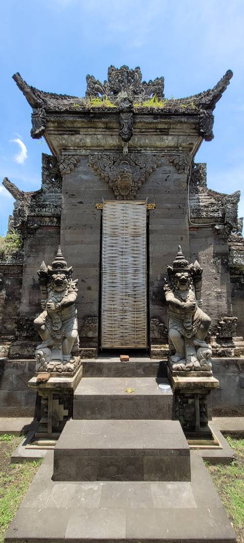 An intricately detailed entrance with statues in a cultural setting.