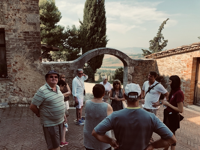       Group of tourists on a tour in a historical site.
  