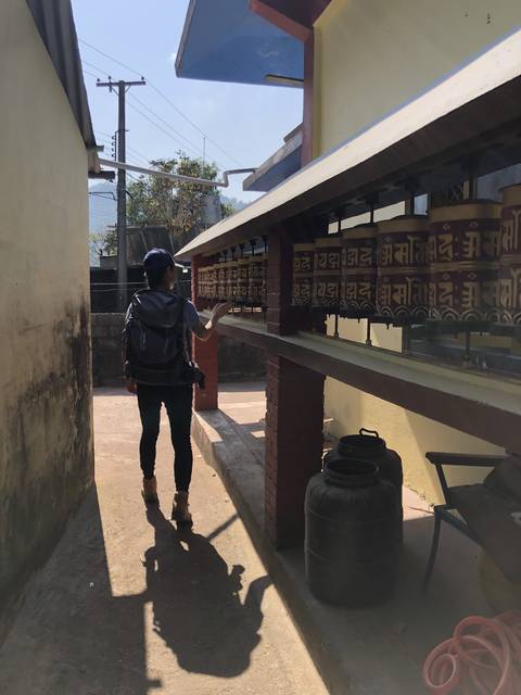 Person walking through a small town with colorful architecture.