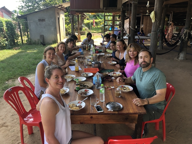 Group enjoying a meal around a table.
