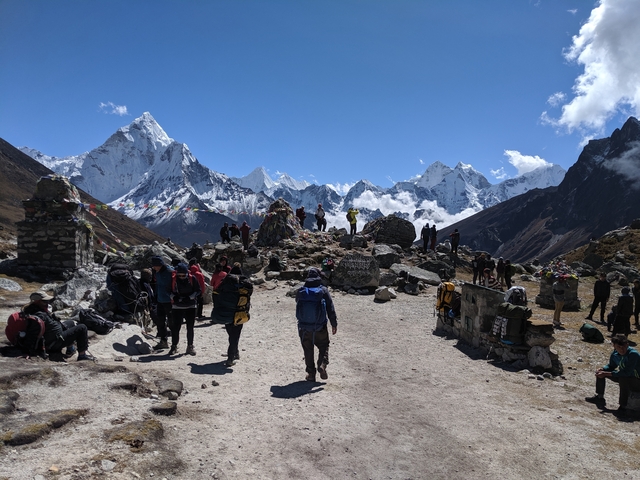 Hikers gathered in a rugged mountain landscape.